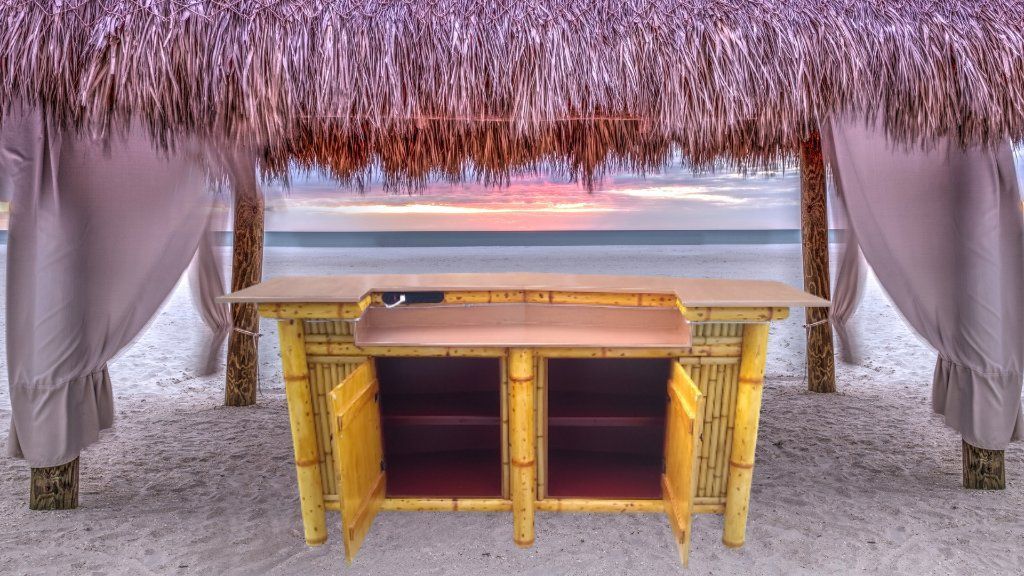 Bamboo Tiki Bar with storage cabinets. Outdoor patio furniture. Dining table