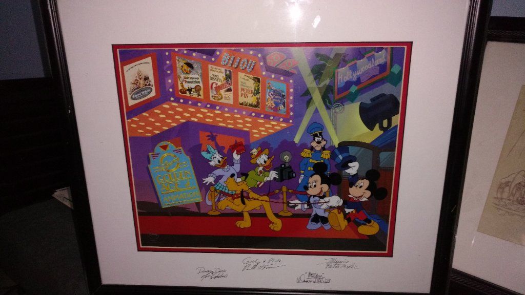 Disney collectible items with papers signed by artist