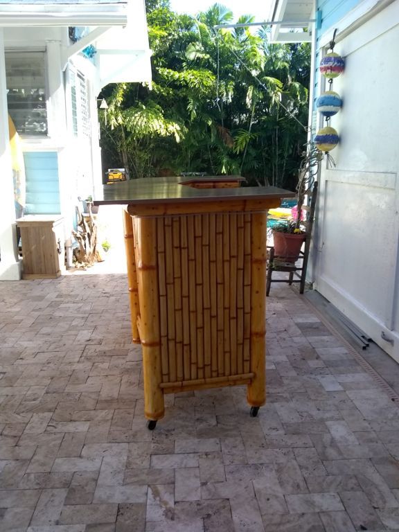 Bamboo Tiki Bar with storage cabinets. Outdoor patio furniture. Dining table