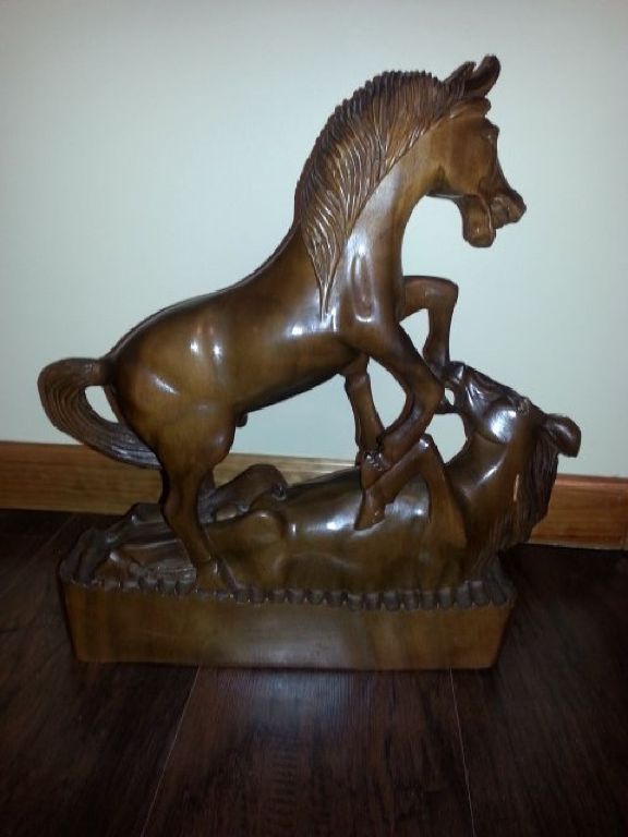 Hand carved fighting horses