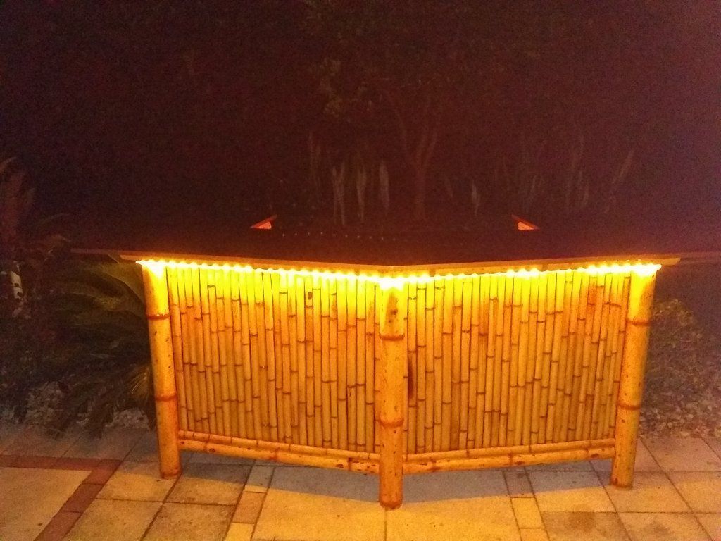 Bamboo Tiki Bar with storage cabinets. Outdoor patio furniture. Dining table