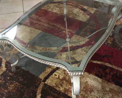Mediterranean style beveled glass top.  Pewter colored curved leg metal base.  Very heavy.  Coffee table:45”x36”x20”. End table: 26”x23”x26”