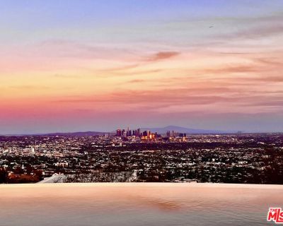 1456 Blue Jay. LEASE TERM TO BE FOR NO LESS THAN ONE YEAR + ONE DAY. AVAILABLE FURNISHED OR UNFURNISHED. Inspired by some of the greatest Art Deco landmarks of our city, this rarified contemporary residence sits commandingly at the end of a gated private driveway flanked by an avenue of palm trees. The two-story entrance hall with its curving staircase leads to a sunken great room with disappea...