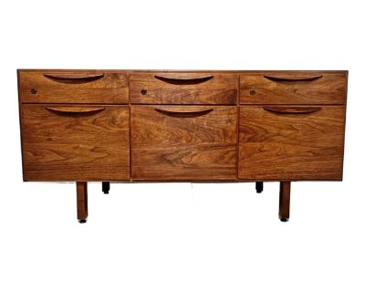 A mid century walnut media cabinet, credenza or dresser by the Danish American designer Jens Risom, circa 1960s. Top three drawers each contain a removalble divider. Bottom three deep drawers each configured to hold files but are quite useful for many purposes including clothing storage.. Dimensions 54.25 W 20 D 26 H Styles Mid-Century Modern Designer Jens Risom Period 1960s Country of Origin U...