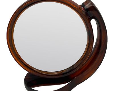A beautiful brown translucent plastic mirror with magnifying glass on one side and a traditional mirror on the other. Can be used as a tabletop mirror or can be wall mounted.. Dimensions 7 W 3.25 D 7 H Styles Art Deco Period Mid 20th Century Country of Origin Hong Kong Item Type Vintage, Antique or Pre-owned Shop Sustainably with Chairish Materials Plastic Condition Good Condition, Original Con...