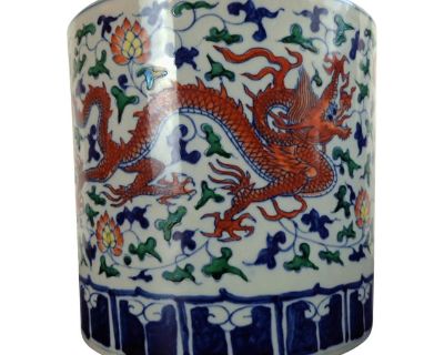 Chinese porcelain red dragon bitong, a finely formed, straight-sided brushpot with a polychrome glazed exterior over a white ground, and a light blue, glazed interior and inset circle centered on the unglazed base. The top of the rim has a band of blue, calligraphic, variations of Arabic letters accented by a thin, blue ringlet. The exterior is decorated with two, freely drawn, red, five-clawed...