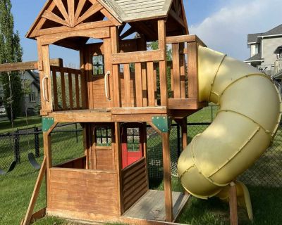 2 storey playhouse with swirly slide & climbing wall