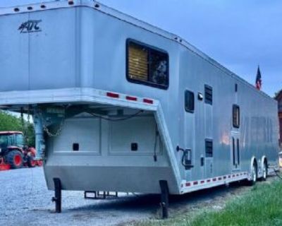 2016 Atc Quest X Living Quarters Trailer This custom 48' 2016 ATC Quest X gooseneck trailer blends heavy-duty hauling with a fully equipped 12' living quarters. Built on an all-aluminum frame, it features two 8,000 lb torsion axles, 215/75R17.5 LRH tires on aluminum wheels, and a 3,000 lb-rated rear ramp door with Advantech floor and diamond plate transition. The finished interior includes blac...
