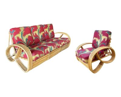 This beautifully restored Paul Frankl style three-strand 3/4 pretzel arm 3-seat rattan sectional sofa and reclining chair set features the well-known 3/4 Reverse Pretzel Armrest on each end with a decorative arch along the base. The sofa is decorated with fancy wicker wrapping and upholstered in tropical palm leaf bark cloth fabric. The lounge chair reclines at 3 different heights and blends st...