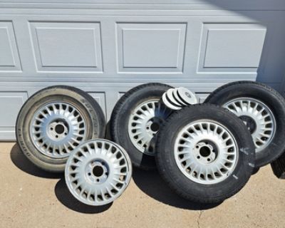 Full set of five 15 inch Buick wheel rims. Four have tires on them. Three are in very good shape with lots of miles left on them. 4th was a spare tire I used. It is on fair shape, just different. The tires are P205/70R15. 95T Hankook Optima. The spare is a Doral. Comes with lug nut caps for the rims. These came off from a '95 or '97 Buick but fits any car with 15 inch rims.