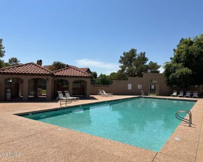 3491 N Arizona Ave Unit 20. Relax in the cozy living room next to the decorative fireplace, complete with fresh paint and stylish vinyl wood plank flooring throughout. The adjacent kitchen features rustic tile countertops, a stainless steel refrigerator, ample cabinet space, and a window overlooking your private backyard-perfect for meal prep with a view. A convenient powder room is also locate...