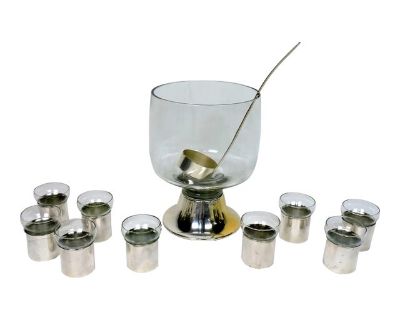 Modern and stylish glass and silver plate punch bowl set made by high quality manufacturer, PM Italy. This set consists of a large glass punch bowl with a silver plated foot, a silver plated ladle, and 9 glasses with silver plated holders. The glasses are removeable from the holders for easy cleaning. The bowl is 12" high by 9" diameter, and the glasses are each 3.5" high by 3" diameter. Marked...