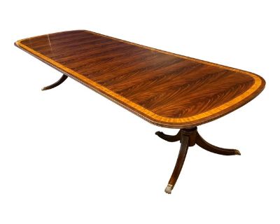 This is Leighton Hall s most popular dining table. It is the LH-7-3L. This table has Leighton Hall a hand steel wool rubbed and polished satin sheen. This allows it to blend in well with existing antiques. The field is swirly crotch mahogany and the two borders are Satinwood and Pau Ferro. The table has a solid mahogany three beaded edge. The fluted three leg pedestals feature antique brass lio...