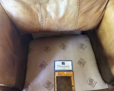 Worn leather with tears but solid.