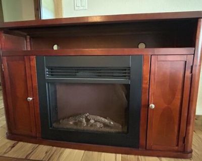 Cherrywood tv stand with electric fireplace. Very good condition. 57 wide, 36