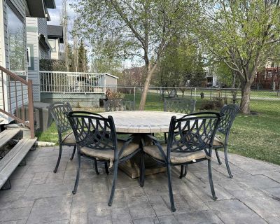 Round Stone Patio Table and 6 Cast Iron Chairs.