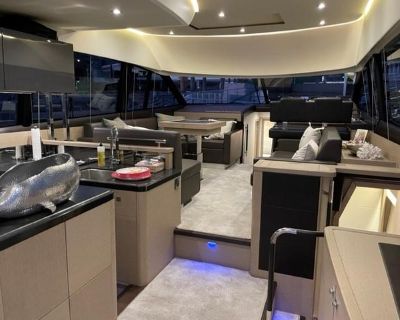 The Prestige 500 Fly boasts one of the finest layouts available in the 50-foot category. It features an integrated hydraulic swim step that maximizes space at the stern while facilitating easy dinghy deployment and retrieval, as well as providing a fantastic swimming area with the option to lower the platform into the water. In the cockpit, you'll find a spacious bench seat accompanied by a hig...