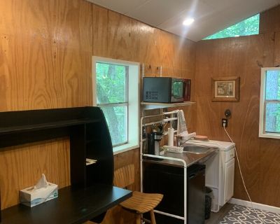 10 x 16 tiny house with toilet, shower, desk , sink, microwave, coffee machine, ac window unit ,electric space heater and bed. It is only suitable for one person because of its size however it has a twin trundle bed under the twin bed both memory foam mattresses so it will sleep two but bathroom is in the same one room living space. 1-7 days. No pets. No children. . 1 Bedroom. 1 Bathroom
