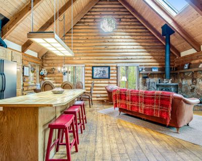 Avg / night: $467. Comfortable cabin home w/wood fireplace, mountain views, National Forest access | Located in Divide, CO | 4.83 Stars | 3 Bed, 3 Bath | No Pets. No pets. Max 12 guests. Nestled away in a beautiful aspen grove on the back side of Pike s Peak, this log home is an ideal retreat for families and groups looking to get away. Multiple skylights flood the space with natural light, whi...