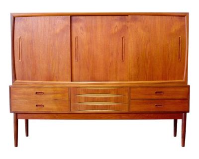Dimensions: 68 3/4 L x 15 3/4 to 19 3/4 D x 52 1/8 H Origin:Denmark Designer: Unknown, in the style of Arne Vodder Manufacturer: Unknown Year: ca 1950s Materials: Teak Details: This highboard has three large sliding doors, curved details, and lower central drawers reminiscent of Arne Vodder s work for Sibast. Unfortunately, we cannot positively ID the designer or manufacturer of this beautiful ...