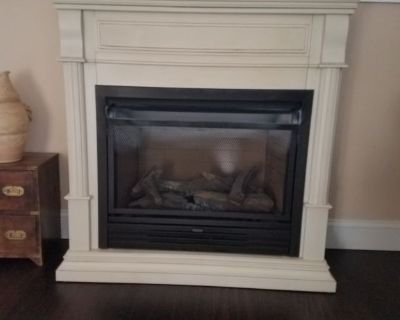Natural gas fireplace.  Perfect condition.  Cream color with darker highlights. Have blower separate not installed