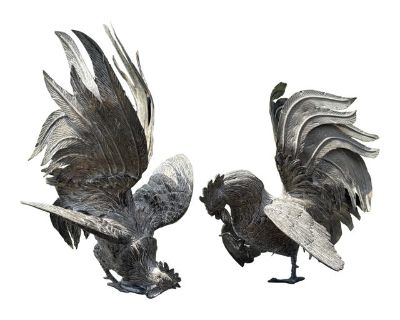 Fighting Cocks! A pair of highly-detailed and uniquely modeled roosters in silver metal. Incredible - and we mean incredible - craft with precise cuts and designs throughout. Portrait quality, with intricate metalwork throughout. They stand as sculpture, and can be positioned in different scenes of engagement. Beautifully balanced and powerful - as in real life. Two figures are completely diffe...