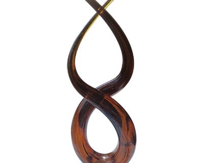 Elegant mid-century art glass sculpture in a warm amber tone, shaped into an infinity loop or flame-like form, mounted on a solid clear glass cube base. The piece features internal aventurine-style sparkle and is hand-shaped, with no mold seams details that support Murano-style attribution. A showstopping centerpiece or accent for collectors of art glass or lovers of fluid, sculptural design. S...