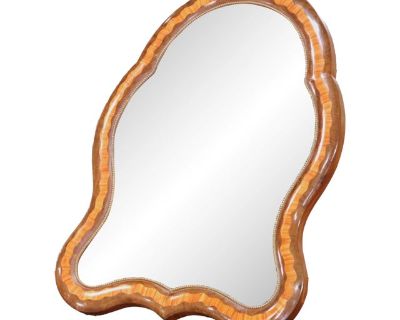 This antique French vanity mirror, crafted circa 1880, reflects the refined elegance of the Louis Philippe style with decorative touches influenced by the Napoleon III period. The shapely frame is veneered in warm walnut and features intricate marquetry in alternating ribbons of light and dark wood, bordered by a delicate gilt beaded trim that highlights the mirror s undulating form. Designed t...