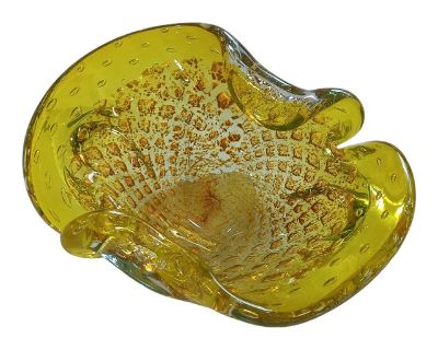 Vibrant yellow hand-blown glass ashtray, Murano-attributed, featuring the classic Bullicante controlled bubble technique with shimmering gold inclusions and a layered Sommerso design. The freeform, organic shape makes this mid-century modern catchall equally functional and decorative perfect as an ashtray, trinket dish, or sculptural accent. This piece is attributed to Murano due to its craftsm...