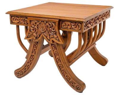 An intricately carved South Asian teak stool or stand, crafted in the form of an elephant saddle with slatted seat. Likely of Burmese or Anglo-Indian origin, circa 1900. The rich hand-carved details and warm patina highlight the artisan craftsmanship of the period. This versatile piece can serve as a low table, display stand, or accent stool.. Dimensions 15.5 W 15.5 D 17.5 H Styles Anglo-Indian...