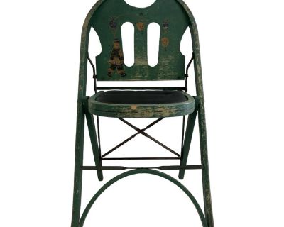 Likely produced in the 1930s or 1940s by the regional U.S. furniture maker St. Louis Folding Chair Company, known for utilitarian wood-and-metal seating. This piece was designed either as a child s chair or parlor accent. The original green paint is beautifully worn, revealing layers of authentic patina and decades of use. Hand-painted figures add a rare, folk-art charm that suggests it may hav...