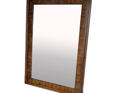 This wall mirror was made by Drexel in 1980 and is from their campaign-style Accolade II collection. Beveled mirror glass and rectangular banded pecan frame. Made in North Carolina, USA. This item is in excellent vintage condition, structurally sound and with minimal cosmetic wear consistent with age and use. Original hanging hardware is intact. Please see photos for a detailed view of this ite...