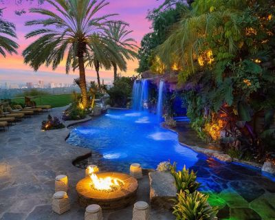 10066 Cielo. This marvelous 21,000 sq ft Andalusian-style estate sits on the clouds of Beverly Hills. An architectural art piece, it boasts 9 bedrooms, 18 bathrooms, and breathtaking panoramic views extending from the coastline to well past downtown Los Angeles. The living room houses an impressive shark tank, with additional tanks located by the bar and in the master bedroom, adding a unique a...