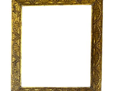 A beautifully aged antique giltwood frame featuring an elegant repeating shell and swag motif a hallmark of late century design and craftsmanship. The raised relief carving gives it wonderful depth and texture, while the time-softened gilding adds warmth and authenticity. The frame s ornamentation, with its alternating shell and foliate garlands, evokes the Neoclassical and Louis XVI styles, ye...
