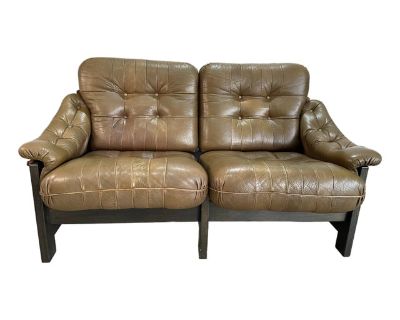Vintage 1970 s Danish or Swedish Brutalist Stained Oak and Olive Green Leather Sling Loveseat. Reminiscent of Brazilian Mid Century and Brutalist designs such as those by Percival Lafer, and Jean Gillon. Black stained oak frame with brown canvas sling with hand stitching details, supported by leather straps with brass buckles. All leather straps have been replaced with new leather. Original pat...