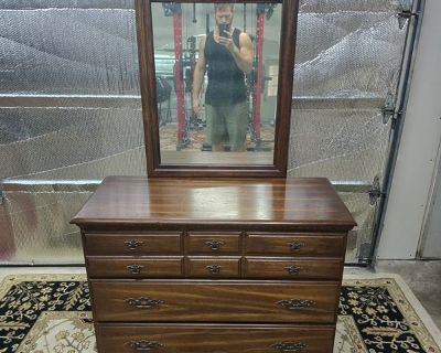 Wood Dresser With Mirror. The mirror is a bit faded but still usable. Measures 42 1/2 wide 18 1/2 long 33 tall and 70 inches tall with mirror. Located in The Woodlands 77381. Crossroad kuykendahl road and research forest drive. Delivery is available for a fee.