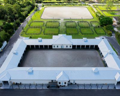 Tamis Trail. Exquisite Equestrian Estate Minutes from WEF. Nestled in a peaceful enclave and inspired by a custom designed Ralph Lauren farm, this newly constructed equestrian facility is designed for the discerning professional. With up to 40 stalls and two elegant living options-- gorgeous three-bedroom staff quarters and a pro residence --this property offers both sophistication and function...