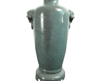 Chinese porcelain oilspot tongping, a finely formed, slim, sleeve shape vase with a turquoise and pale violet, oilspot glazed exterior and inset base and a turquoise glazed throat and interior. The vase is accented with wide striations of pale violet. Two, finely carved and detailed, taotie handles flank the shoulder of the vase. The wide, stepped and crenellated foot has one convex ringlet abo...