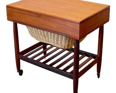 Dimensions: 23 1/2 L x 16 D x 23 1/8 H Origin: Viby J, Denmark Designer: Ejvind A. Johansson Manufacturer: Vitr for FDB M bler Year: ca 1950s Materials: Teak, Walnut, Cane Details: Produced by Vitr for FDB M bler (who outsourced much of their manufacturing to other workshops), this elegant sewing table has a cane lower basket with storage above and an open shelf of walnut below. It was popular ...