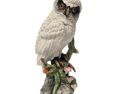 Beautiful white ceramic owl perched on a tree branch.The eyes are striking, so intense.The bird is looking around, almost as if it's staring right at you. Deep orange and black eyes. The feathers are all snowy white and the tree he is perched on is colorful. Green and gold leaves, with some gray in the branch.This would look great in just about any style room. Coastal, lake house, cabin? Signed...