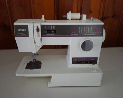 Singer sewing machine with white wood cabinet
