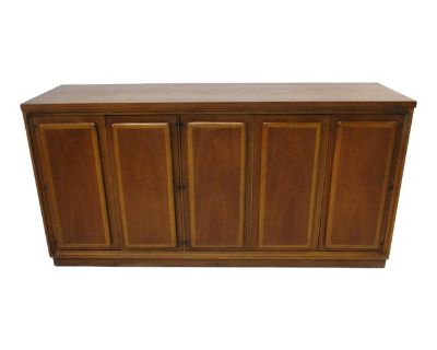 A walnut Mid Century credenza / server with two toned door edges which give the piece a unique aesthetic . To the left side four large drawers and to the right a bi -folding door with two adjustable shelves with plenty of storage . Very well crafted by the Broyhill Premier furniture company from their Forward '70 collection .. Dimensions 60 W 17.13 D 30.5 H Styles Mid-Century Modern Brand Broyh...