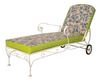 A charming 1960s wrought iron chaise lounge chair featuring a decorative floral motif, perfect for adding vintage character to any patio, sunroom, or garden space. The sturdy wrought iron frame showcases timeless mid-century style, built to last with both beauty and function in mind. The lounger is in great shape, with some light wear, scuffs, and markings to the frame consistent with normal us...