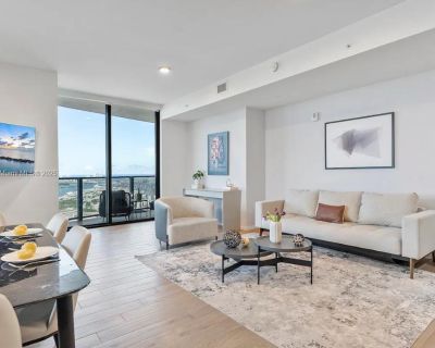 NE 5th St. Experience luxury living at The Elser Hotel Residences. This fully furnished 2-bed, 2-bath corner unit features direct Bay and skyline views, floor-to-ceiling windows, an Italian kitchen with quartz countertops, custom cabinetry, premium appliances, and in-unit washer/dryer. Enjoy 5-star amenities: rooftop resort-style pool and spa, modern fitness center, sky lounge, coworking lab, L...