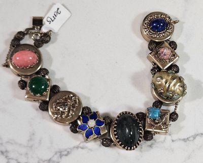 Unsigned, gold tine metal with glass stones. Measures... 7-1/2" long 3/4" wide @ 5/8" deep Excellent condition... clasps function properly Free Shipping no pickup