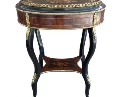 A stunning, French, Napoleon III, marquetry jardini re. Features extensive wood marquetry work and gilded bronze mounts. The lift/off tray is embellished with florals and branches encircling a torch in lightly tinted shades highlighted by a darkened pear background. The center medallion is surrounded by thuya veneer accents. Comprised of rosewood and various veneer and marquetry woods. Retains ...