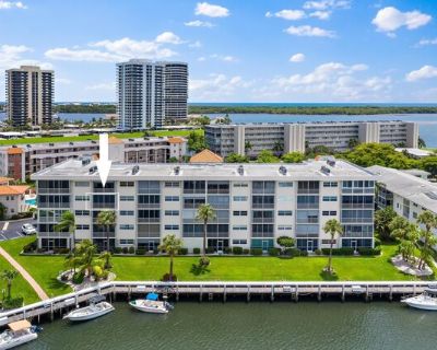 29 Yacht Club Dr Apt 407. BEAUTIFUL RENOVATION! Waterfront Retreat in 55+ ''Ports O Call''. Enjoy breathtaking sunsets over the North Palm Safe Harbor Marina from your living room/enclosed patio and master bedroom. Bright and spacious featuring custom cabinetry, beautiful flooring, chefs delight kitchen w top-level appliances, designer lighting fixtures and fans. Covered parking space a few ste...