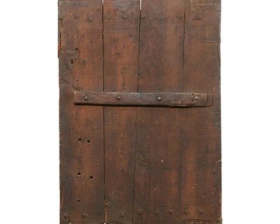 A single Turkish wooden door with rustic hand-carved embellishments from the 19th century. This antique door from Turkey has a simple and bucolic feel to it, with hand-carved circular and line patterns lightly decorating its front, along with the original iron hardware and thick nail heads. The door is shorter than a standard door height, as it is approximately 4.75 feet tall. The wood has a lo...