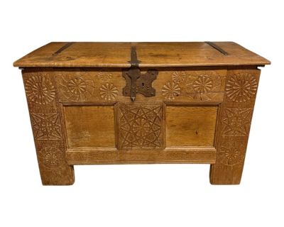 An extraordinary 18th-century Dutch oak trunk, signed and dated Jahn Mertin c.1722, its surface alive with the hand of its maker. The front is a symphony of chip-carved rosettes some large and radiant, others tightly knotted and intricate each catching light in a way that feels almost architectural. Heavy wrought iron strap hinges frame the lid, paired with the original lock (its key, sadly, lo...