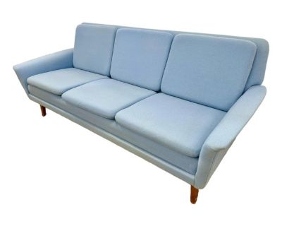 Crafted by Folke Ohlsson for Fritz Hansen, this sofa captures the essence of midcentury style, featuring supple curves and understated sophistication. Upholstered in a serene blue wool. Secure this rare Midcentury Danish Modern Sofa an investment in design history.. Dimensions 73 W 31 D 28 H Styles Mid-Century Modern Seat Height 17.0 in Number of Seats 3 Arm Height 20.0 in Brand Fritz Hansen De...